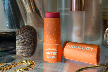 Tinted Dew Multi-Stick in Humble on a makeup counter